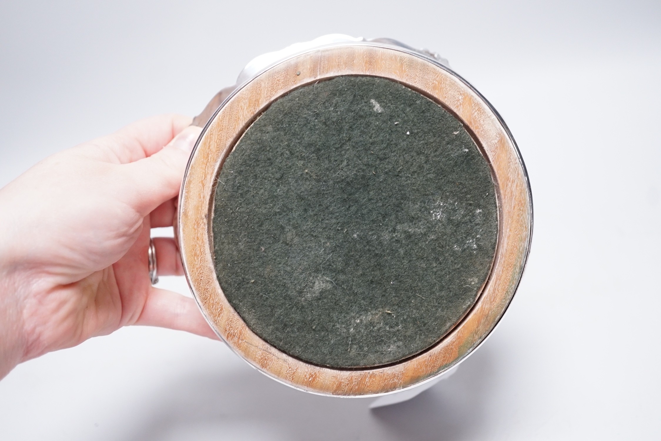 An early Victorian silver mounted wine coaster, with scrolling border, marks very rubbed, possibly London, 1838, diameter 16cm.